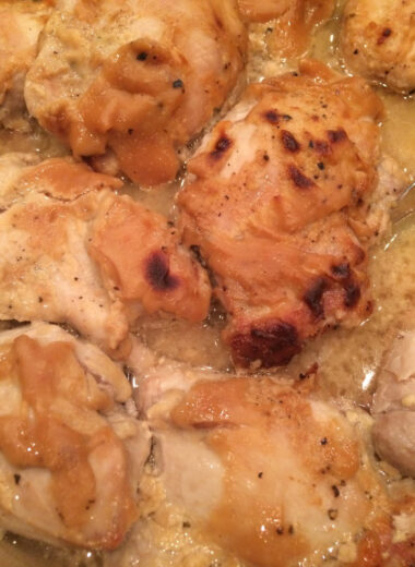 A pan with honey mustard chicken on it.