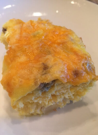 A plate with a piece of egg casserole on it.
