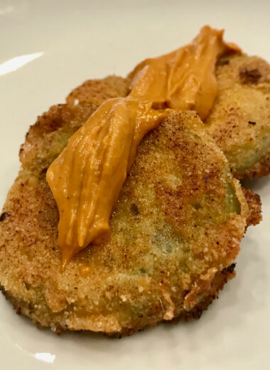These fried green tomatoes are elevated with a spicy kick by adding in spicy seasoning.