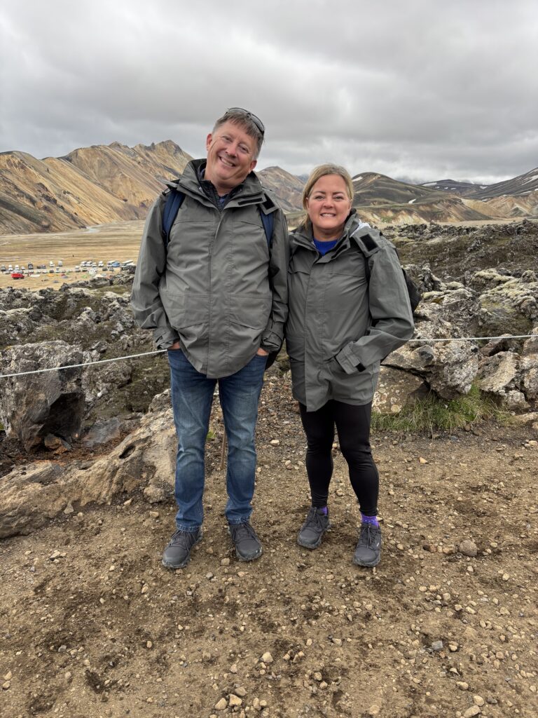 A picture of a couple in front of a glacier in Iceland